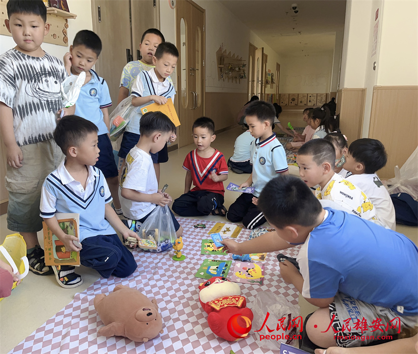 圖為“集市行樂”活動中，學生用“悅容幣”進行交易。雄安容和悅容幼兒園供圖